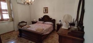 a bedroom with a bed and a dresser and a mirror at A casa da Nonna Sara in Mazara del Vallo