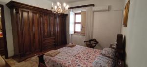 a bedroom with a bed and a chandelier at A casa da Nonna Sara in Mazara del Vallo +6 photos