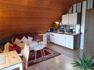 a living room with a couch and a table at Haus Alexandra in Bad Driburg