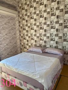 a bed in a room with a brick wall at Fly House 飛航家民宿 in Hualien City