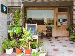 a store front with a bunch of potted plants in front at 綠色的日子 in Nantou City