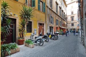 a row of motorcycles parked on a city street at Corallo Apartment in Rome