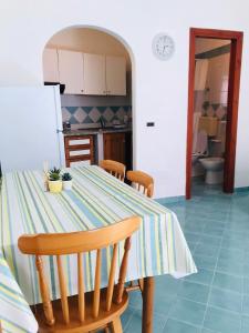 a kitchen with a table with a striped table cloth at Casetta Forio in Forio d'Ischia +7 photos