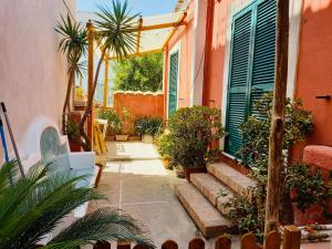 a courtyard of a house with plants and trees at Casetta Forio in Forio d'Ischia