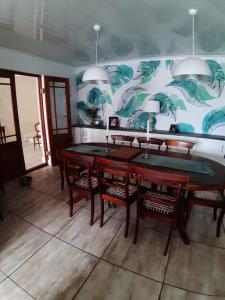 a dining room with a table and some chairs at Olive Tree Cottage in Paternoster