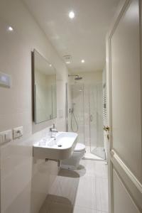 a white bathroom with a sink and a shower at Ca' del Pittor Apartments in Venice