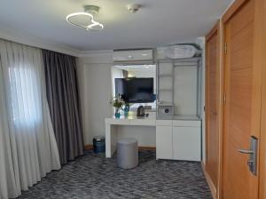 a hotel room with a desk and a television at Turk Art Hotel in Istanbul