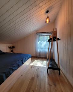 a bedroom with a bed and a ladder in it at Beach House Trimpas 