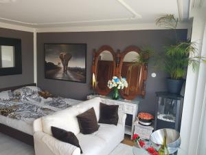 a living room with a couch and an elephant painting at Penthouse with beautiful 360 terrace in Schaan