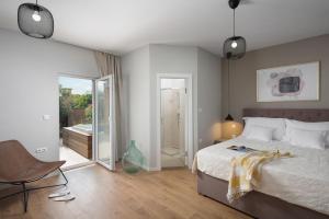 a bedroom with a bed and a sliding glass door at Villa Stanzietta Novigrad for 10 at Olive orchard in Novigrad Istria +68 photos