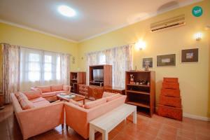 a living room with two couches and a tv at 300m from beach - Luxury Mediterranean Holiday House - Pets Welcome in Bang Sare