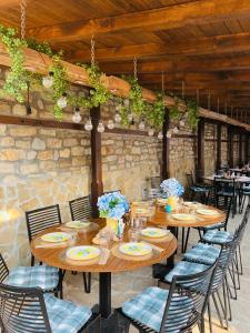 a dining room with wooden tables and chairs at Соколови къщи in Gabrovo