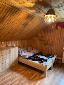 a bedroom with a bed in a wooden room at Agroturystyka u Czepiela in Ochotnica Górna +58 photos