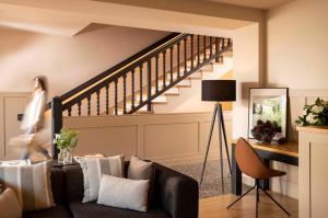 a living room with a couch and a staircase at Villa du Pyla in Pyla-sur-Mer