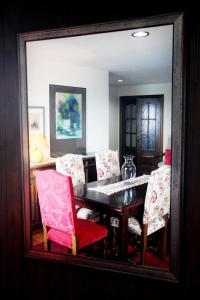 a dining room with a table and chairs in a mirror at Apartamentos Turísticos Las Nieves Playa in Llanes