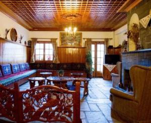 a living room with a couch and a table at Hotel Bitouni in Metsovo