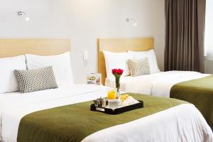 Rúm í herbergi á Unipark by Oro Verde Hotels