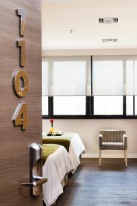 Rúm í herbergi á Unipark by Oro Verde Hotels