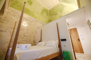 a bedroom with a bed with a ceiling at BAYIT Charming Place in Polignano a Mare