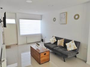 a living room with a couch and a coffee table at Casa nueva, excelente ubicación in Punta Arenas