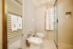 a bathroom with a toilet and a glass shower at BAYIT Charming Place in Polignano a Mare