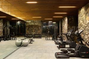 a gym with a row of treadmills and exercise equipment at Radisson Resort and Spa Lonavala in Lonavala