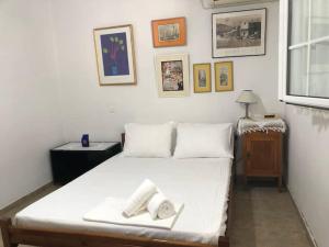 a bedroom with a bed with two towels on it at Strofilia Farm House, Kalogria! The Sea, The Forest, The Sun in Kamenitsotaíika