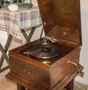a wooden dresser with a clock on top of it at Strofilia Farm House, Kalogria! The Sea, The Forest, The Sun in Kamenitsotaíika