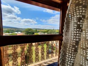 a view from a window of a balcony at Pousada Luz do Sol in Carrancas