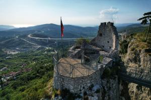 a castle on top of a mountain with a flag at Apartment Beautiful Črni Kal in Črni Kal