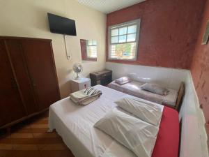 a bedroom with a bed and a couch in it at Hotel São Paulo in Poços de Caldas