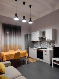 a kitchen with a table and a dining room at Le Muse in Licata