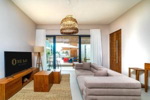 a living room with a couch and a table at One Bay Residence Modern Contemporary Apartment Flat 4 in Grand Baie