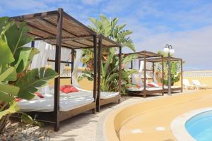 two beds on the roof of a resort with a swimming pool at Quinta Nova Vale Del Rey in Carvoeiro
