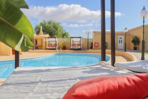 a bed in front of a swimming pool at Quinta Nova Vale Del Rey in Carvoeiro