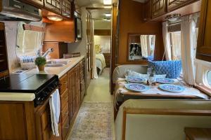 a kitchen with a table with plates on it at Beautiful Airstream, Beaufort SC-Enjoy the Journey in Beaufort