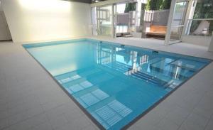 a swimming pool with blue water in a house at Auto Lodge in New Plymouth