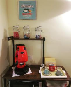 a red coffee maker sitting on a table at Rega Holiday House in Naples