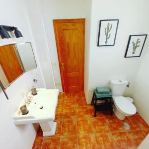 a bathroom with a white sink and a toilet at Agua Amarga Design in Agua Amarga