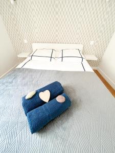 a bedroom with two blue towels on a bed at La Capitainerie in Cancale