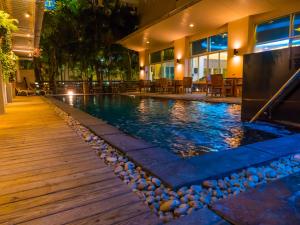 a swimming pool in a hotel at night at Atrium Boutique Hotel in Bangkok