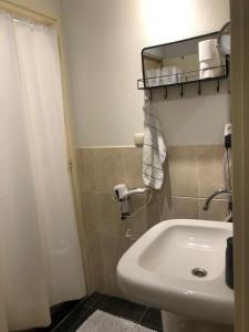a bathroom with a white sink and a mirror at GUESTHOUSE UIT DE KUNST in Leeuwarden +9 photos