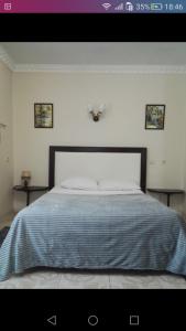 ベルゴロドにあるоднокомнатная УЮТ на1этаже ПАРКのベッドルーム1室(大型ベッド1台、青い毛布付)