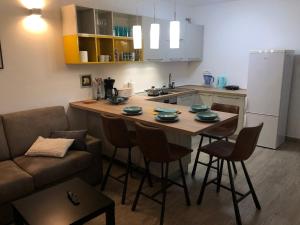 a kitchen with a table with chairs and a couch at Pula Center Seaview Apartment in Pula +16 photos