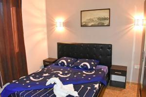 a bedroom with a bed with a stuffed animal on it at Apartments Murati in Ulcinj