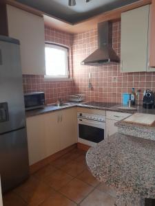 a small kitchen with a sink and a refrigerator at T1 SolTroia in Troia