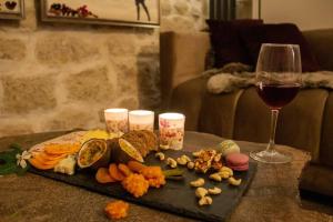 a table with a plate of food and a glass of wine at Tiny Gallery Paris Gare Montparnasse in Paris