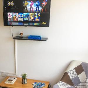 a living room with a tv on a wall at Mi casa es tu casa - PC Home in El Calafate