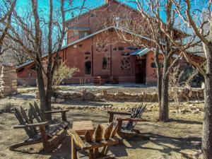 a group of chairs in front of a building at EcoMalargüe Posada & Hostel in Malargüe