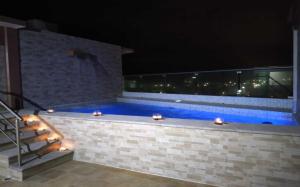 a swimming pool at night with lights on it at Harbour Inn - Veracruz in Veracruz